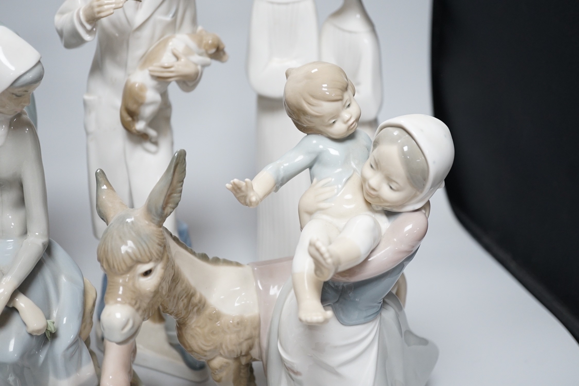 A collection of nine Lladro porcelain figures, tallest 36cm